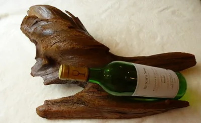 Driftwood wine cradle holding a bottle on its side