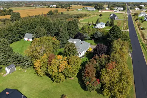 The house and gardens from the air as the leaves start to turn