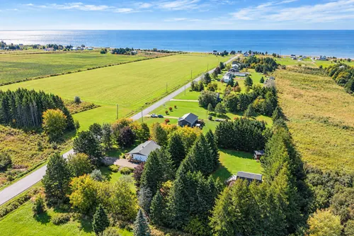 The property among the fields, with the shore beyond